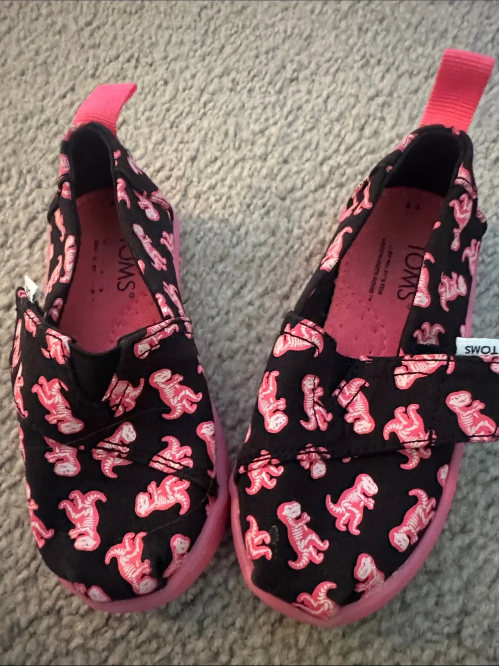 Toms Kids Black Canvas Slip-Ons with Pink Dinosaur Print